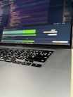 A close-up of hands typing on a laptop with AI graphics.
