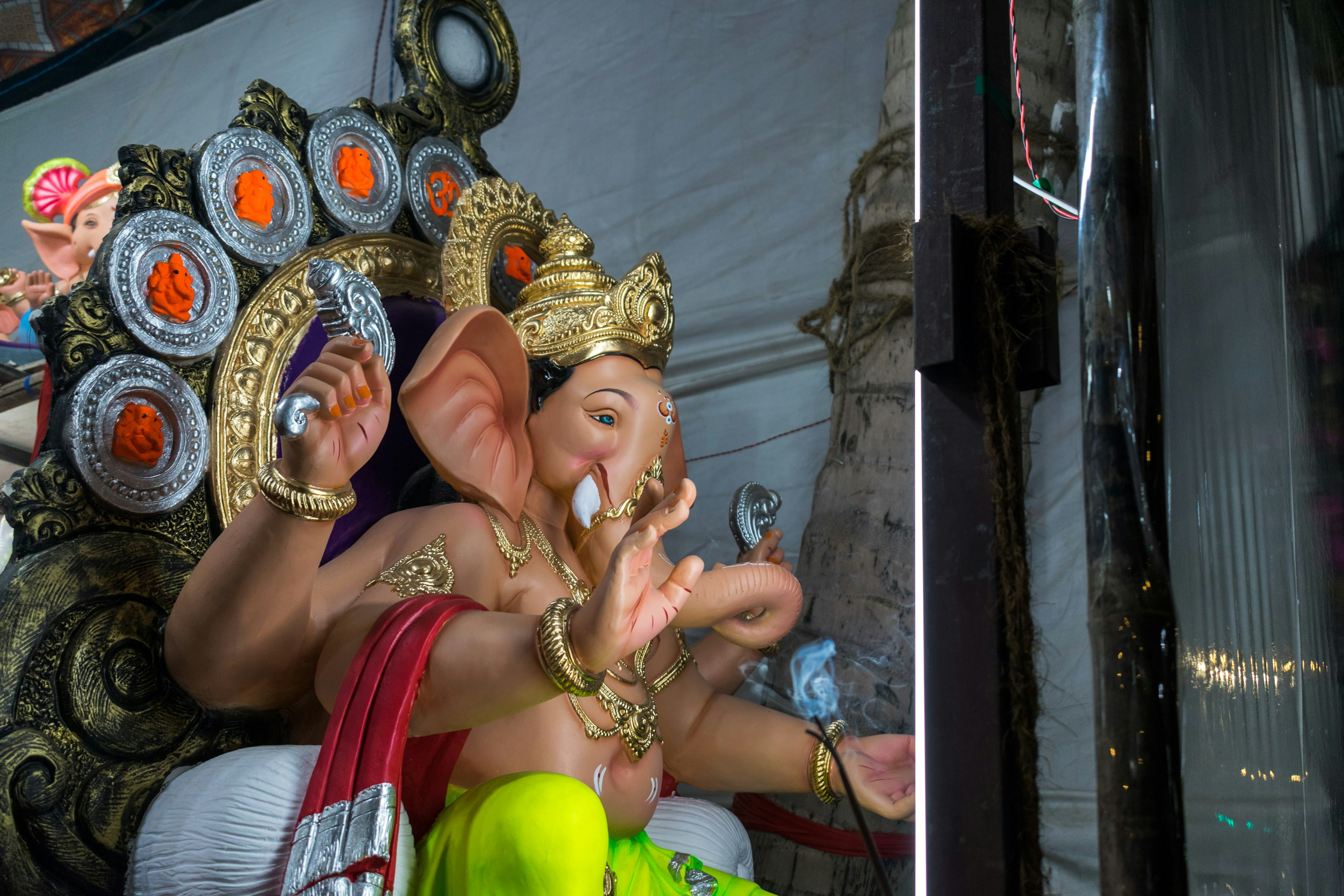 a statue of an elephant with its trunk in the air