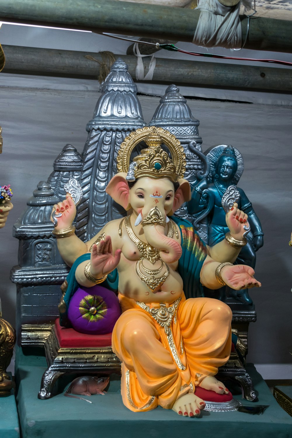 a statue of a ganesh sitting on a bench