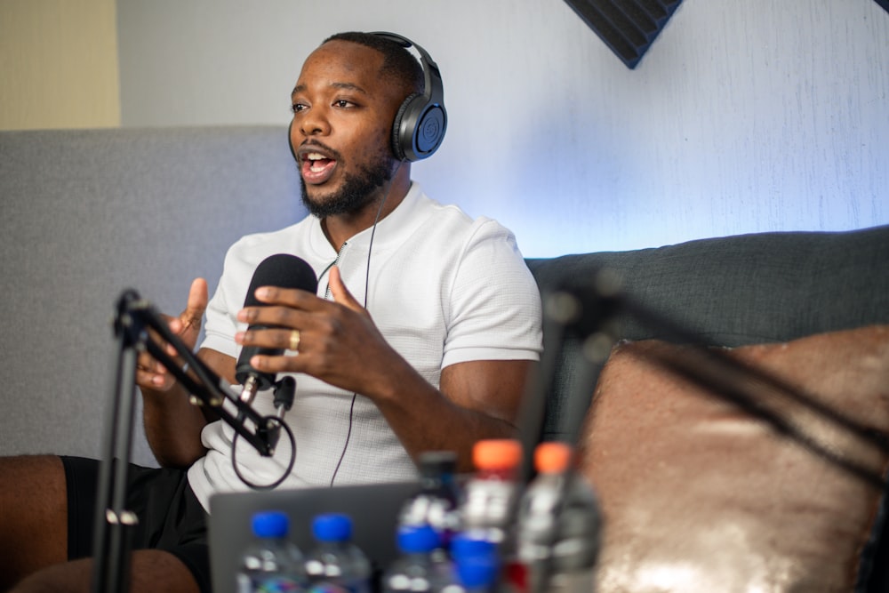 a man sitting on a couch with headphones on