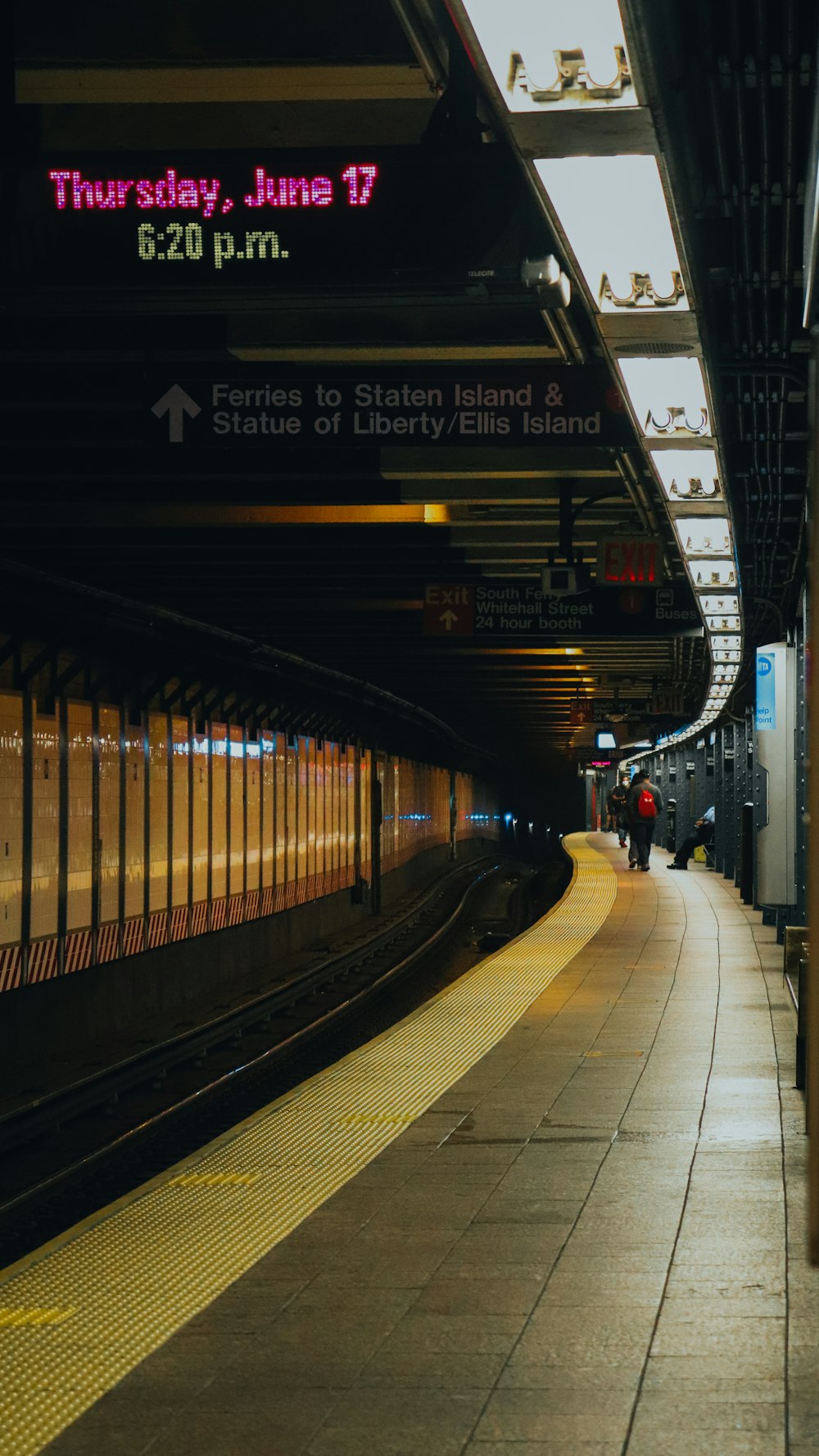 a subway station with a train pulling into it