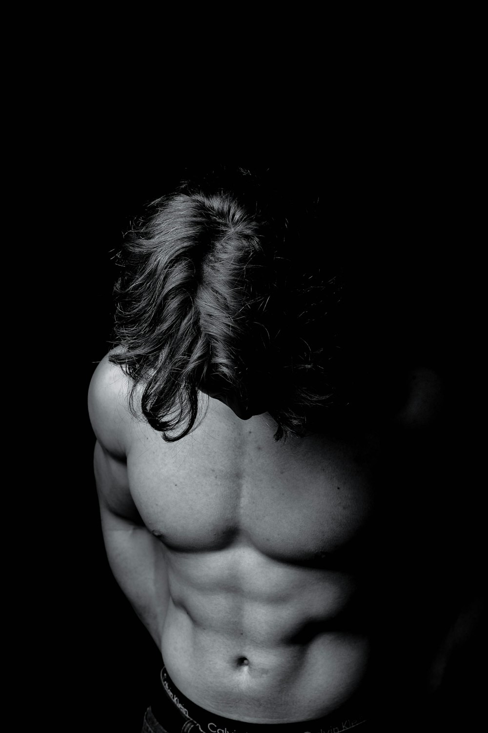 a shirtless man with long hair and no shirt