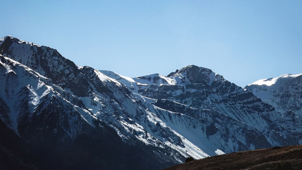 a mountain range with snow covered mountains in the background