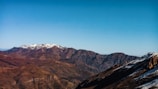 a view of a mountain range with snow on it