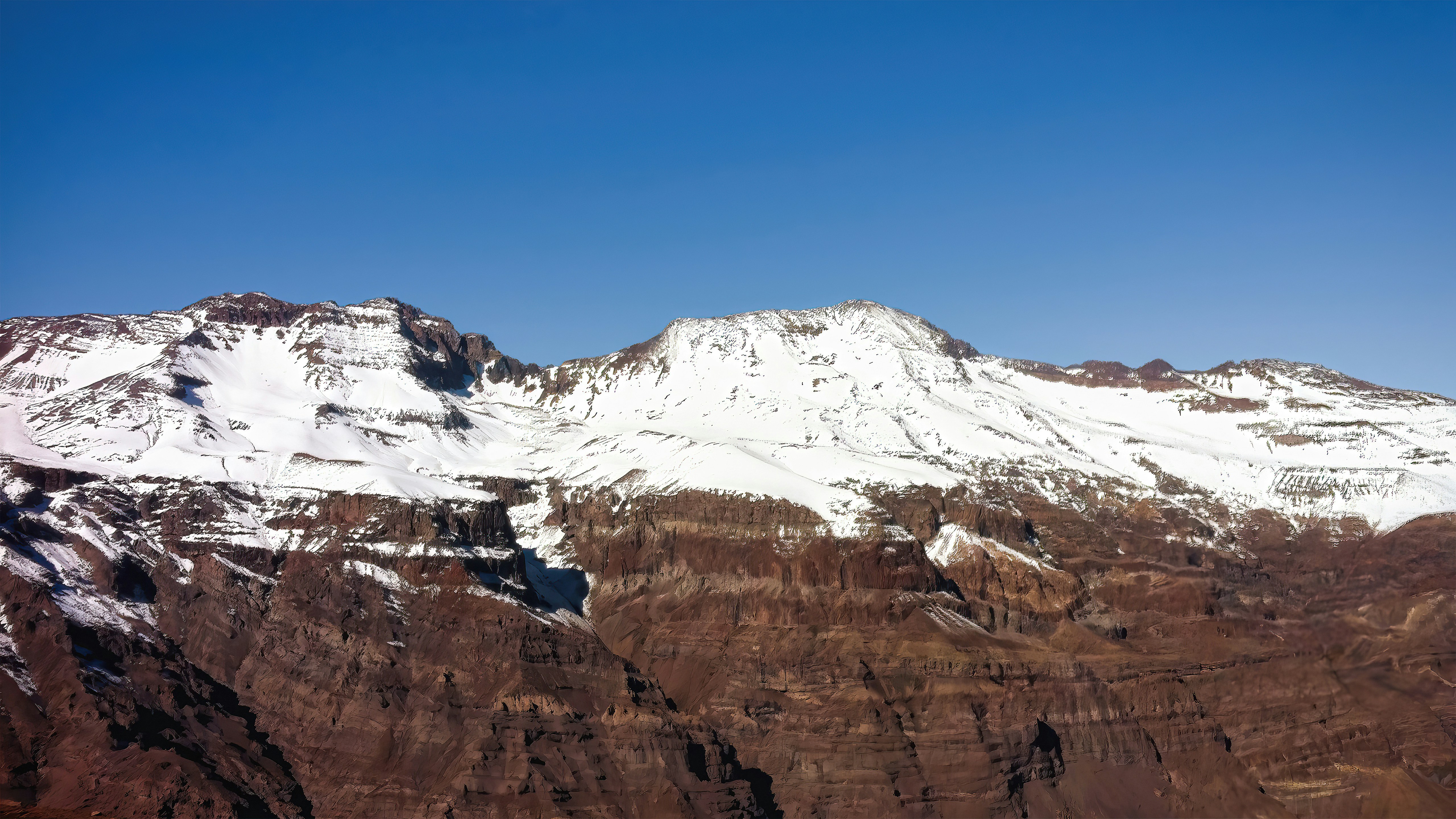 a snow covered mountain with a clear blue sky