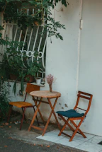 A cozy garden scene with a small wooden table and plants, inviting contact.