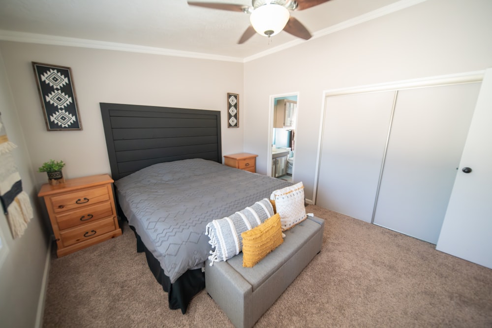 a bed sitting in a bedroom next to a dresser