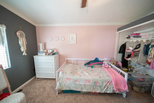 A cozy nursery corner with soft pastel colors and baby toys arranged neatly.