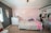 A cozy nursery with soft toys and pastel-colored decor for a baby's room.