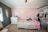 A cozy nursery with soft toys and pastel-colored decor for a baby's room.