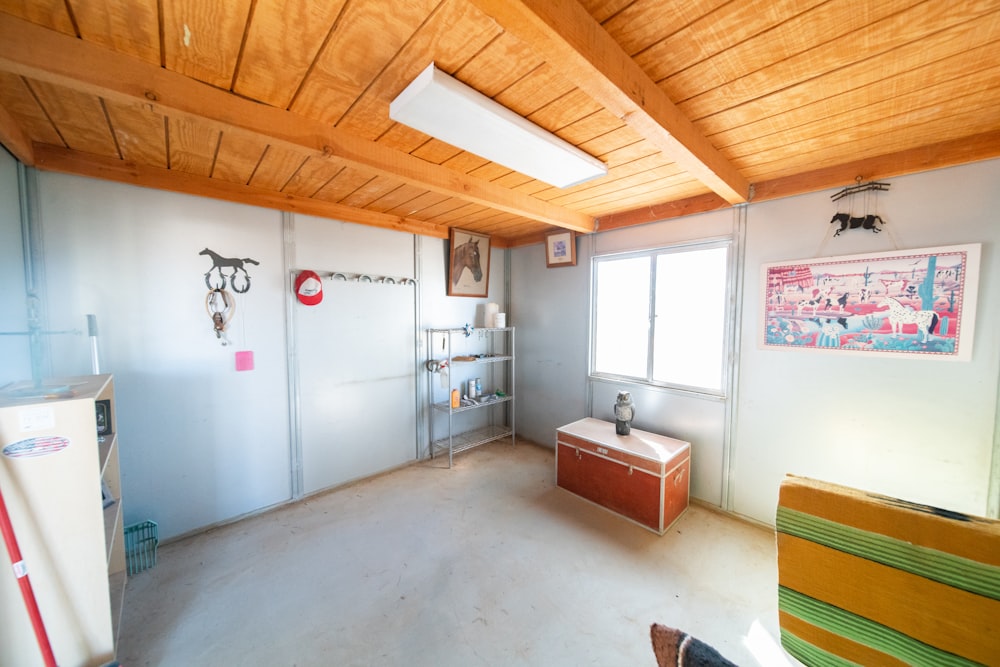 a room that has a refrigerator and a table in it