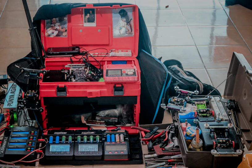 Close-up of a sleek electronics workstation with circuit boards and soldering tools under cool blue lighting.