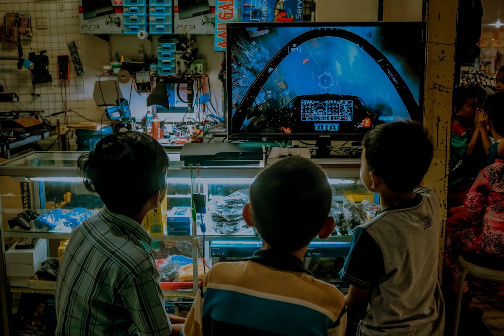 two boys looking at a video game in a shop