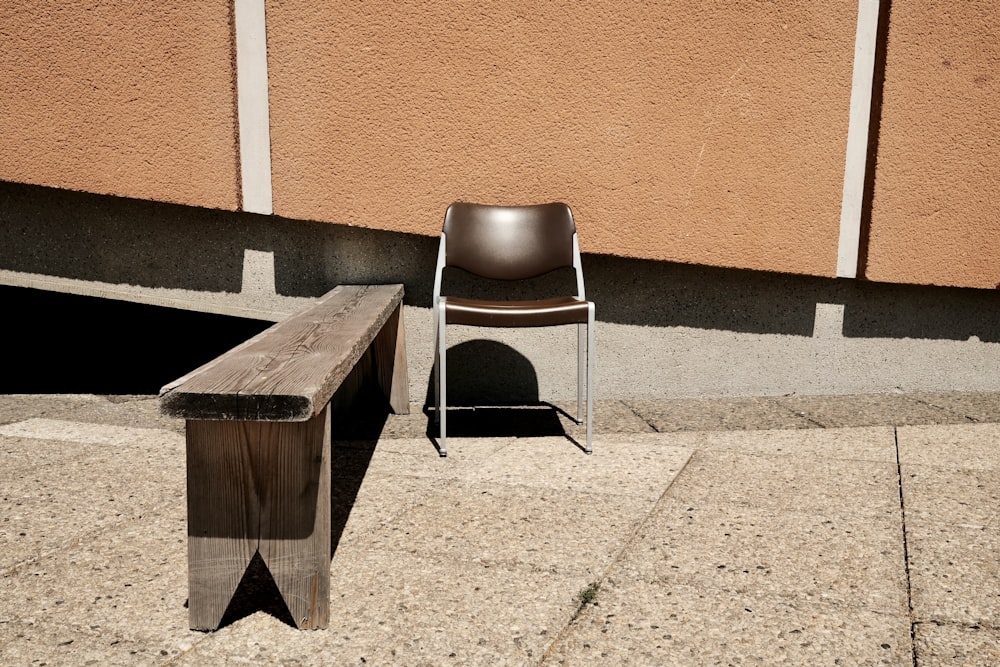 a chair sitting next to a wooden bench