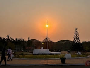 A serene sunset behind the JP Blecksmith memorial site, with flags gently waving in the breeze.