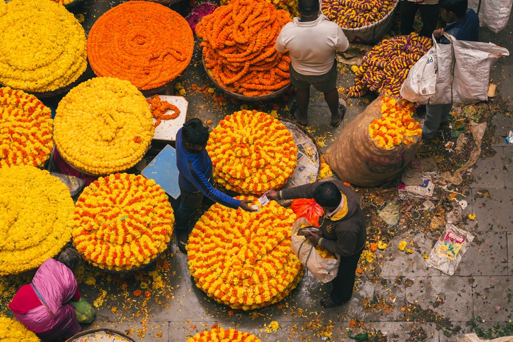 a group of people standing around a bunch of flowers