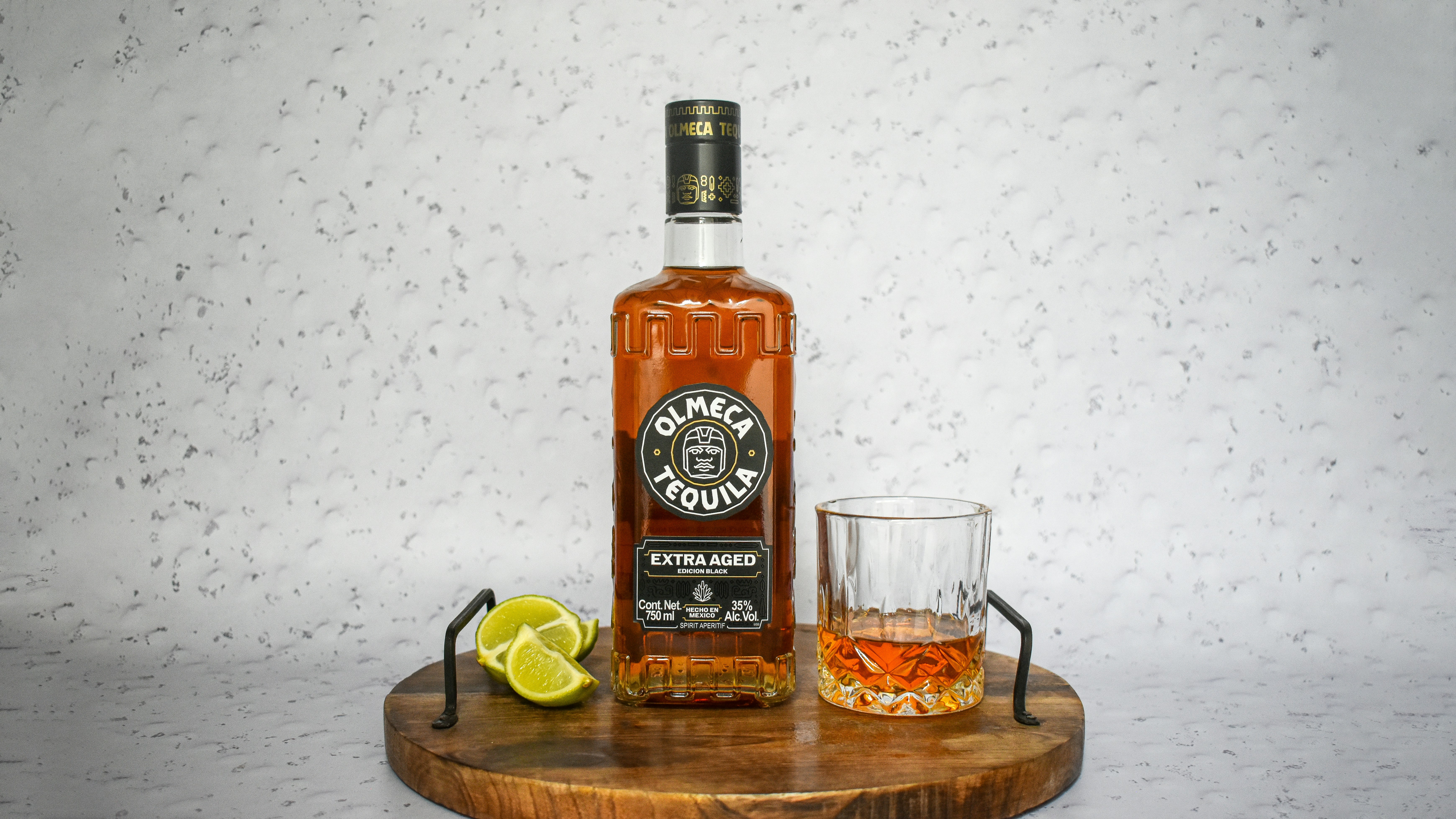 A bottle of starbucks coffee liqueur next to a shot glass photo Free