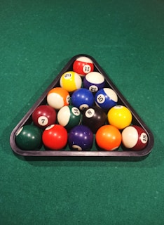 A detailed shot of colorful billiard balls racked tightly before a break.