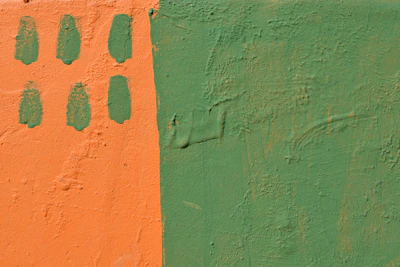 Brightly painted living room wall in warm orange tones with clean edges and fresh paint.