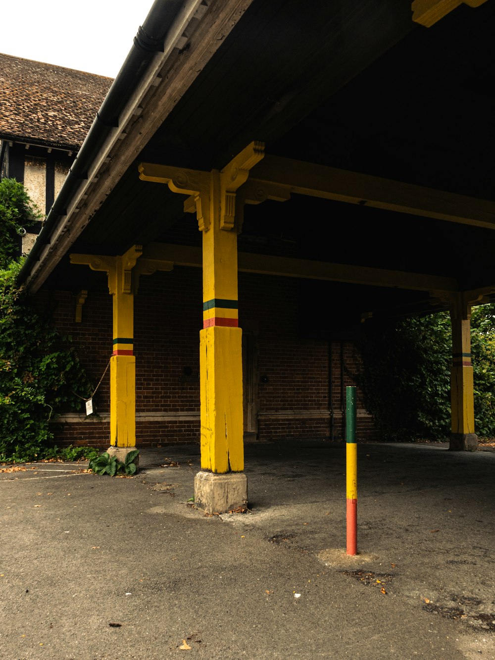 a yellow and green pole in a parking lot