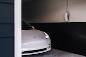 A clean, modern garage with electric and hybrid vehicles being serviced.