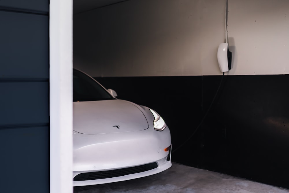 a white car is parked in a garage