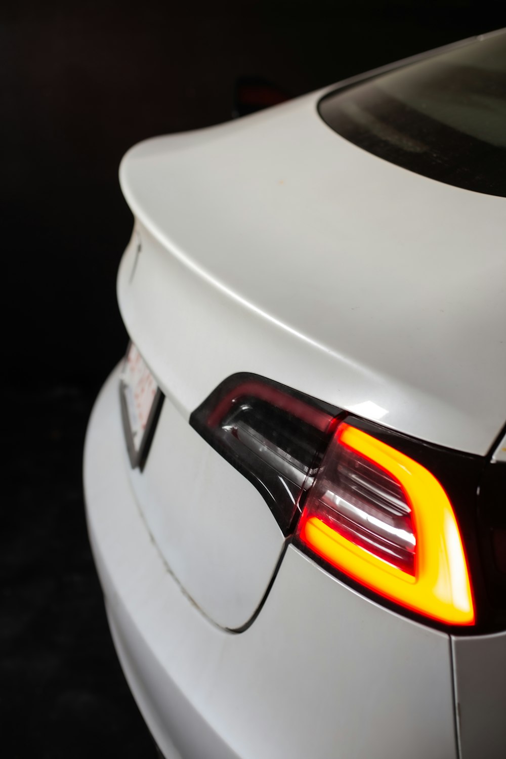 a close up of the tail lights of a white car