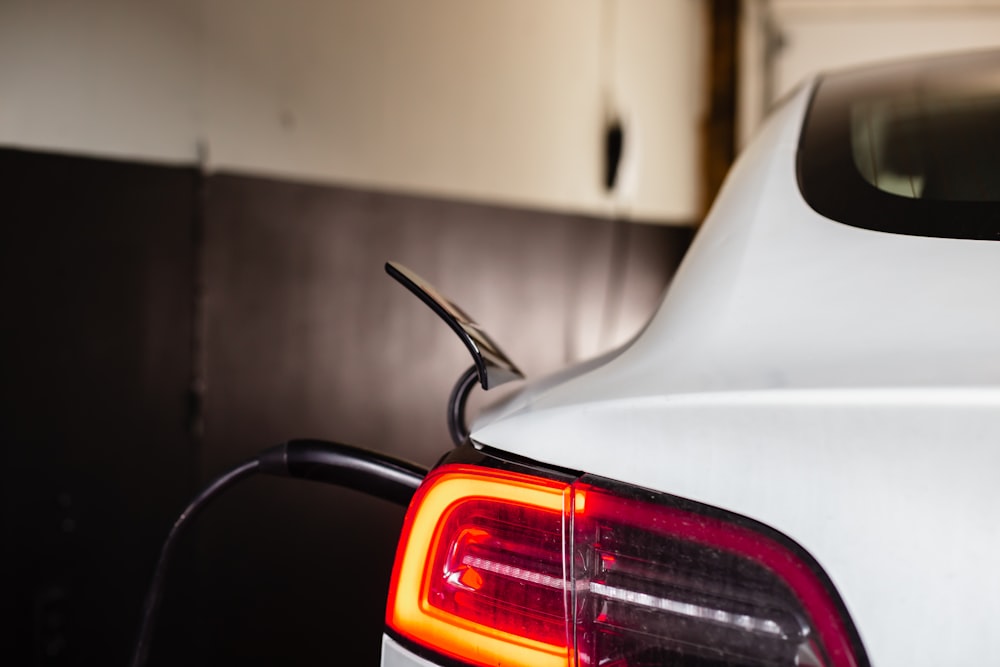 the tail light of a white car in a garage