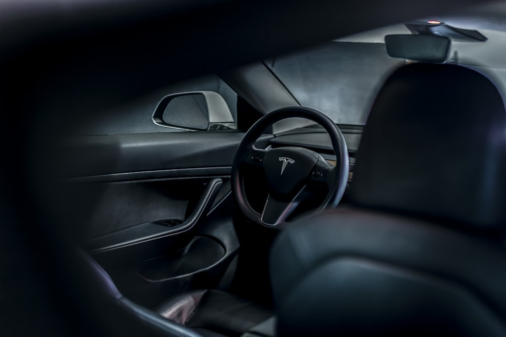 the interior of a car with a steering wheel and dashboard