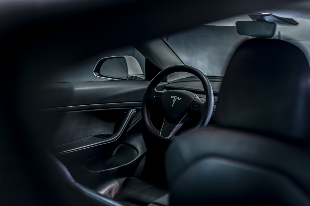 Electric car interior showing steering wheel and dashboard displays