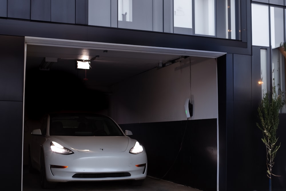 a white car is parked in a garage