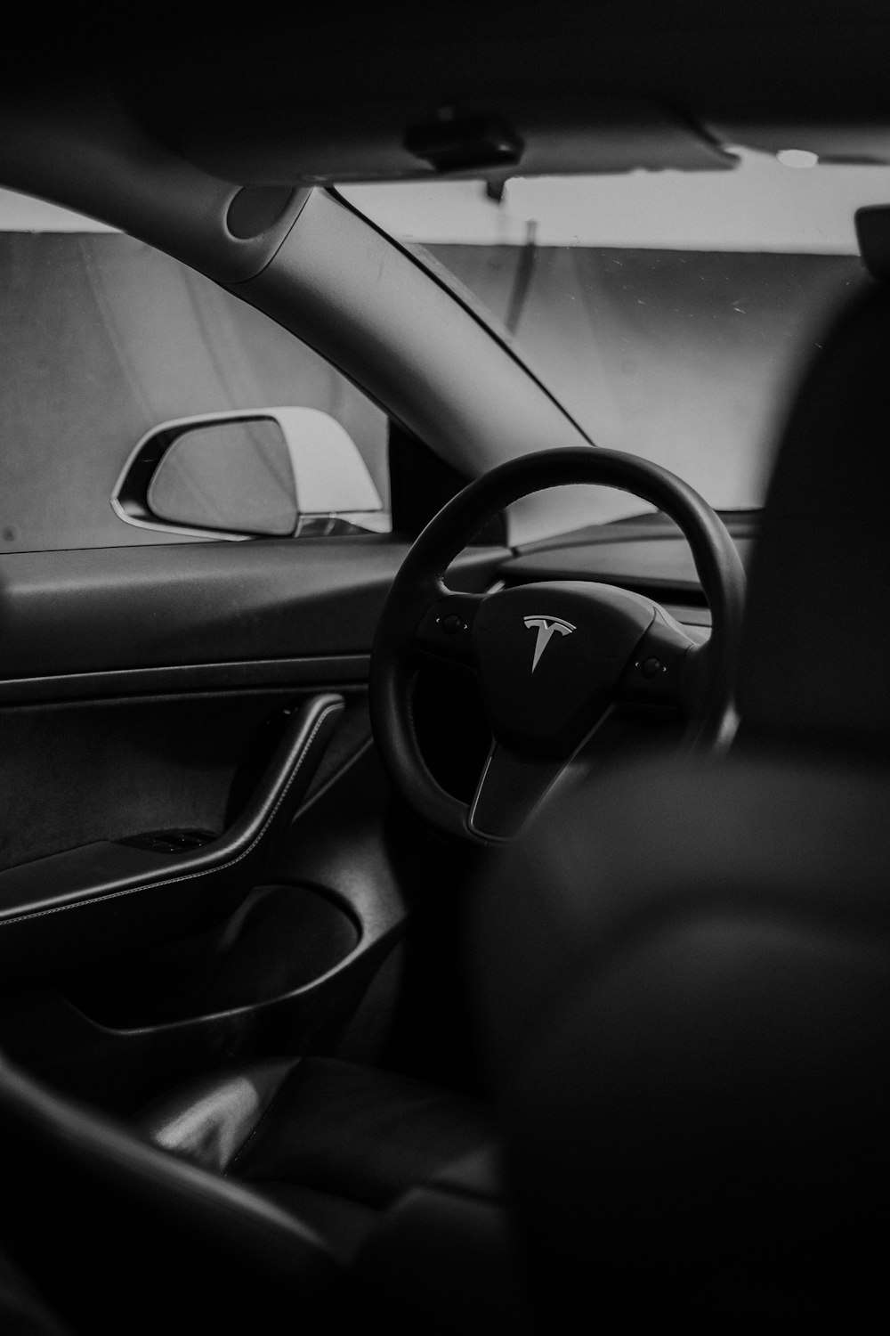 a black and white photo of the interior of a car