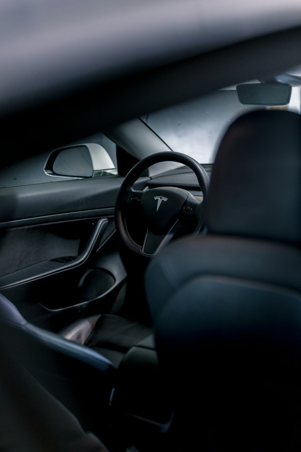 the interior of a car with a steering wheel and dashboard