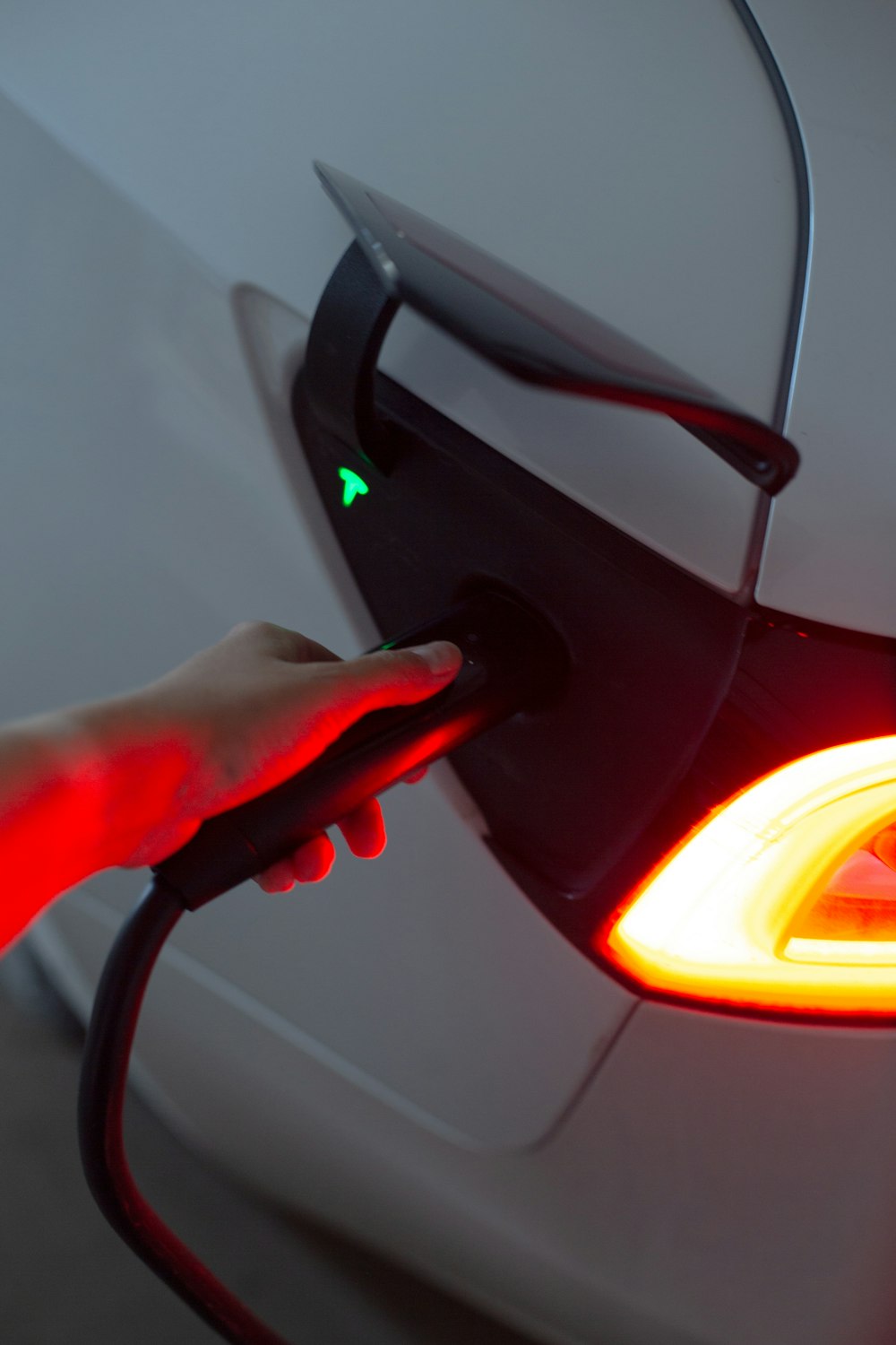 a person is charging a car with a green light