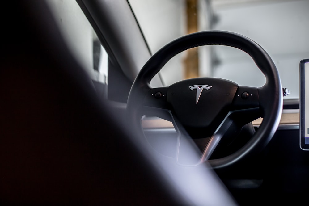 the dashboard of a car with a tablet next to it