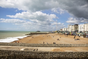Seaside resort with beachfront properties and tourists relaxing by the water.