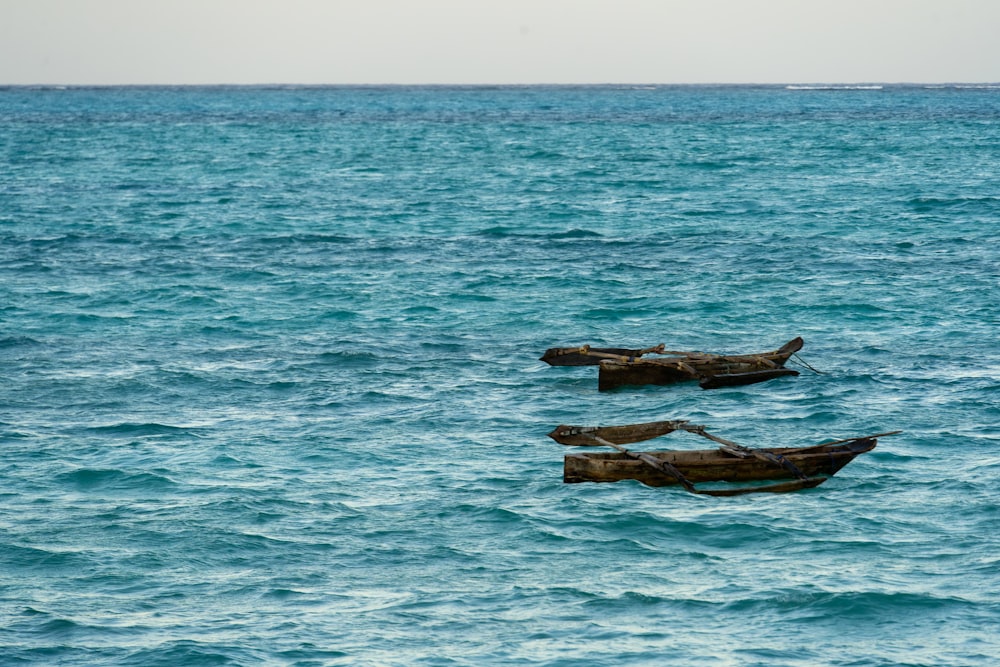 a couple of boats floating on top of a large body of water