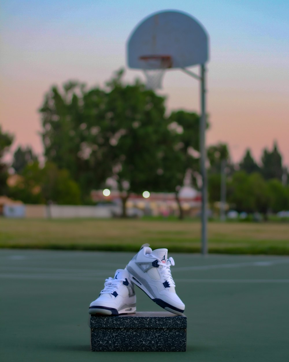 a pair of shoes sitting on top of a basketball court