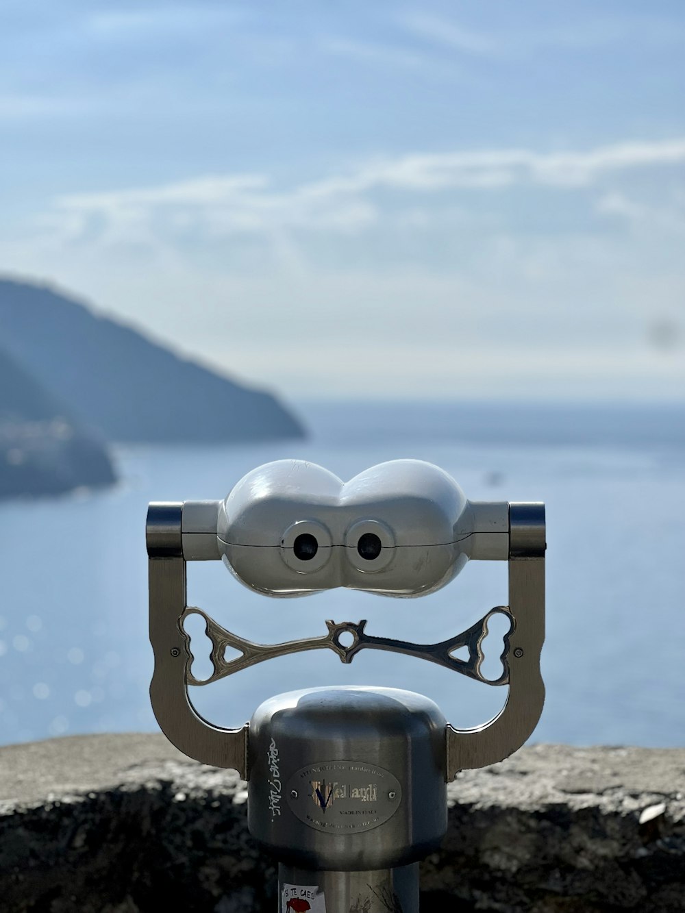 a close up of a metal object near a body of water