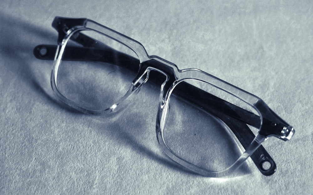 a pair of glasses sitting on top of a table