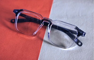 a pair of glasses sitting on top of a table