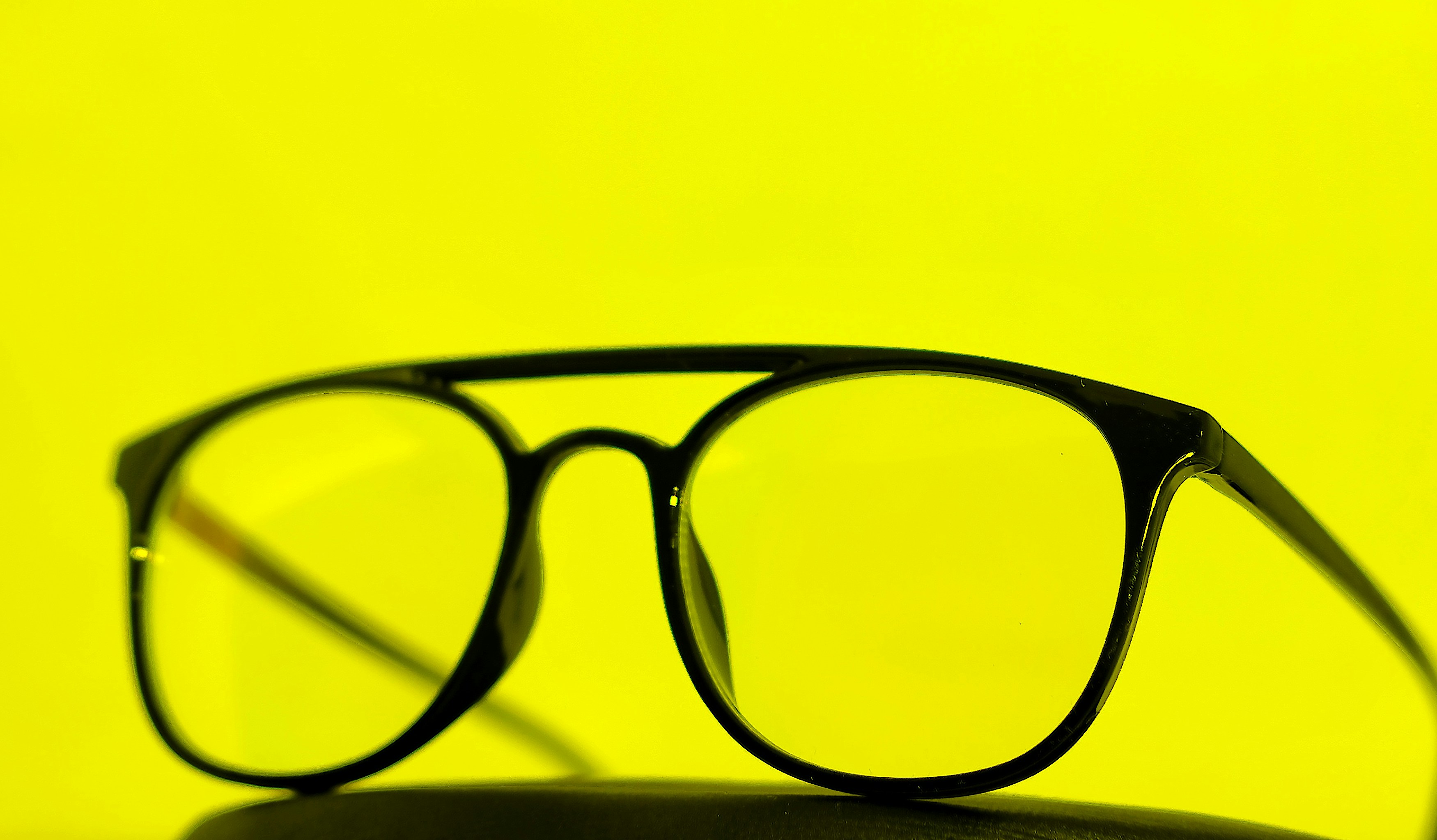 a pair of glasses sitting on top of a table