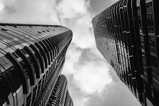 a black and white photo of two tall buildings