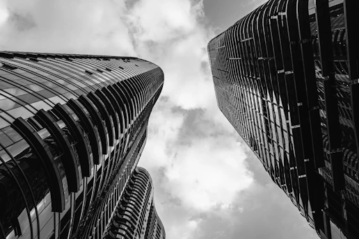 a black and white photo of two tall buildings