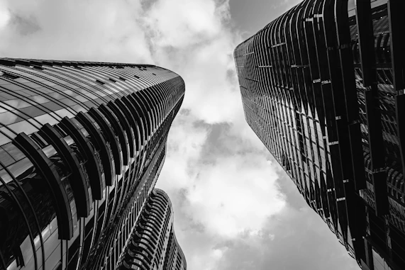 a black and white photo of two tall buildings