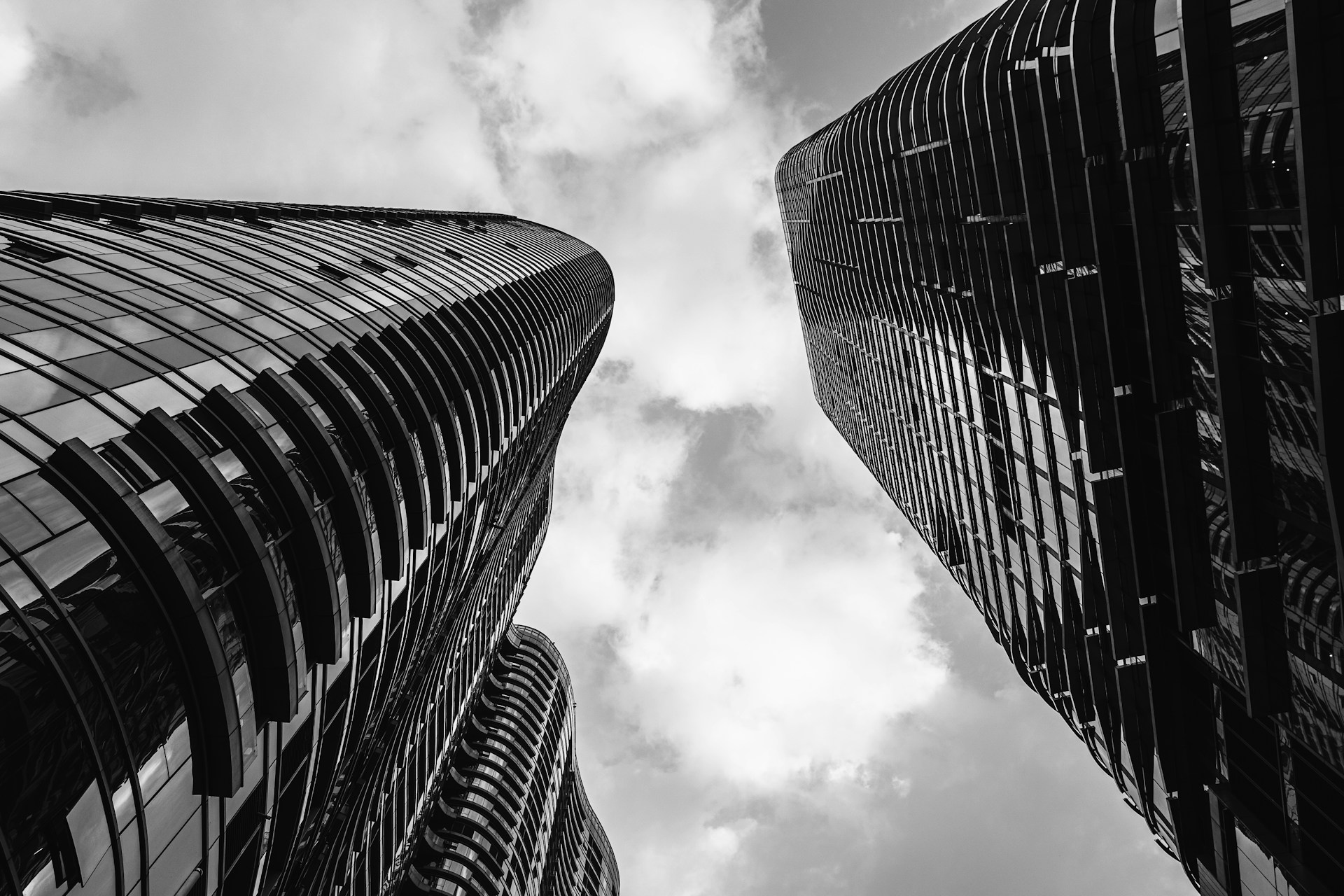 a black and white photo of two tall buildings