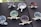 Several ceramic bowls with unique designs featuring sculpted arms and legs on a black surface are arranged in a scattered pattern. Each bowl has a pair of chopsticks resting on top. The bowls have a variety of colors, including hints of blue, purple, and red.