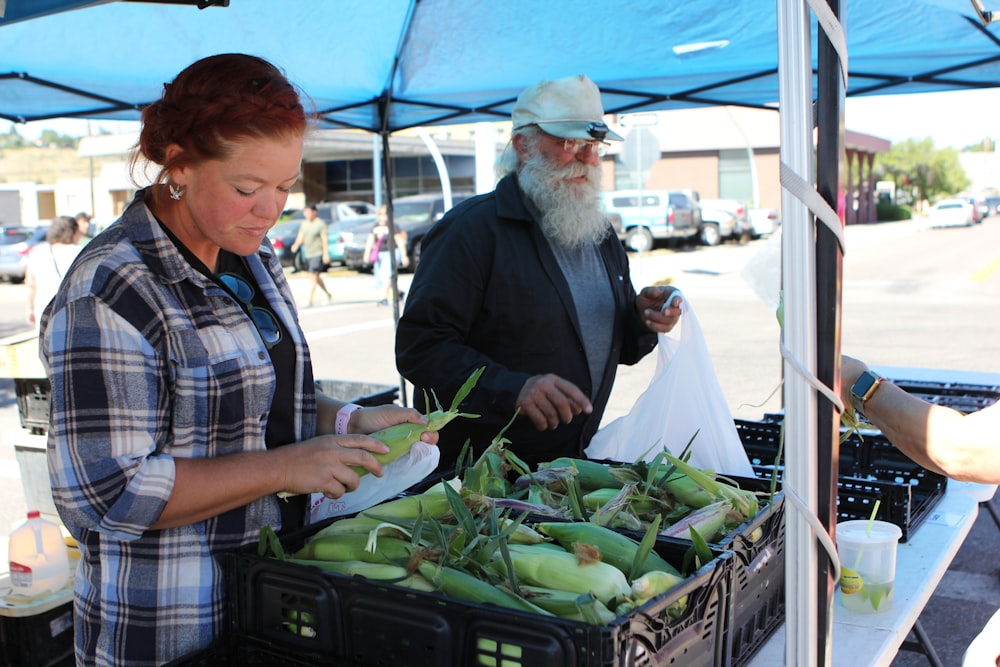 a man and a woman at a farmers market