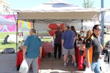 Members organizing a charity bake sale in the town square.