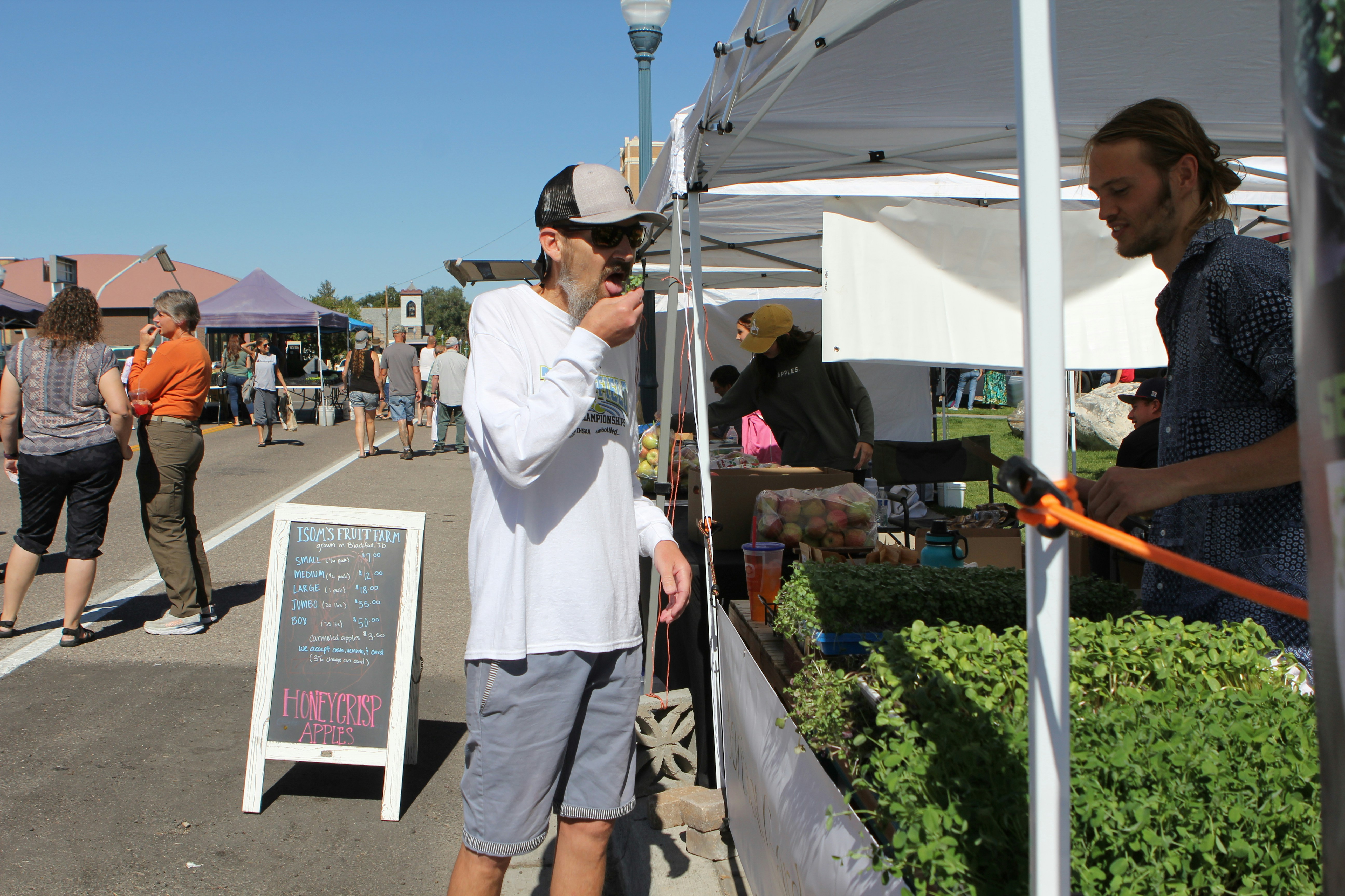 a man standing next to a white tent